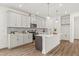 Stylish kitchen with white cabinetry, stainless steel appliances, and a center island at 408 W Paris St, Tampa, FL 33604