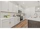 Modern kitchen with white cabinets, granite countertops, tile backsplash, and stainless appliances at 408 W Paris St, Tampa, FL 33604