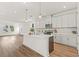 Spacious kitchen featuring a central island, white cabinetry, and modern lighting fixtures at 408 W Paris St, Tampa, FL 33604