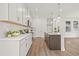 Bright kitchen with white cabinets, quartz countertops, stainless appliances, and island seating at 408 W Paris St, Tampa, FL 33604