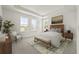 Elegant primary bedroom featuring tray ceiling, large windows, neutral color palette, and stylish furnishings at 408 W Paris St, Tampa, FL 33604