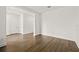 Bright, empty bedroom with hardwood floors, neutral walls, base trim and access to hallway and en-suite bathroom at 410 W Paris St, Tampa, FL 33604