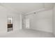 Empty bedroom with access to an en-suite bathroom and walk-in closet, plus neutral walls and light colored carpet at 410 W Paris St, Tampa, FL 33604