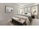 Relaxing bedroom with neutral colors, natural light, tray ceiling and a cozy bench at the foot of the bed at 410 W Paris St, Tampa, FL 33604