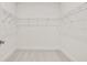 This empty closet has white walls and a wire shelf at 410 W Paris St, Tampa, FL 33604