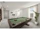 Upstairs game room with a pool table for entertainment, windows, carpet and an open landing at 410 W Paris St, Tampa, FL 33604