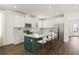 Modern kitchen with white cabinets, a spacious island, and stainless steel appliances, perfect for cooking at 410 W Paris St, Tampa, FL 33604