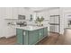 Modern kitchen with green island, white quartz countertops and stainless steel appliances at 410 W Paris St, Tampa, FL 33604