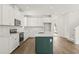 Bright kitchen features white cabinets, stainless steel appliances, subway tile backsplash, and a beautiful center island at 410 W Paris St, Tampa, FL 33604