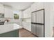 Bright kitchen featuring white cabinets, stainless steel fridge and subway tile backsplash at 410 W Paris St, Tampa, FL 33604