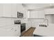 Bright kitchen featuring white cabinetry, quartz countertops, and modern stainless steel appliances at 410 W Paris St, Tampa, FL 33604