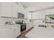 Well-lit kitchen with white cabinets, subway tile backsplash, and stainless steel appliances at 410 W Paris St, Tampa, FL 33604