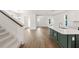 Open floor plan features a staircase, tile floors, natural light and a kitchen island for easy entertaining at 410 W Paris St, Tampa, FL 33604