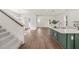 Open living space with wood floors, stairs, and kitchen island view, bathed in natural light at 410 W Paris St, Tampa, FL 33604