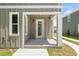 This inviting front porch has a white support beam and a light at 410 W Paris St, Tampa, FL 33604