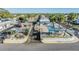 Aerial view showcasing community pool and shuffleboard courts with meticulous landscaping and a charming water feature at 4851 W Gandy Blvd # B3L35, Tampa, FL 33611
