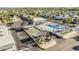 Aerial view of community amenities including bocce ball, pool and clubhouse surrounded by mature trees at 4851 W Gandy Blvd # B3L35, Tampa, FL 33611