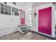 Exterior back door with gray steps, a pink storm door, and a large pink storage door at 4851 W Gandy Blvd # B3L35, Tampa, FL 33611