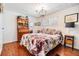Cozy bedroom boasts wood floors, natural light, a bookcase, and decorative details at 4851 W Gandy Blvd # B3L35, Tampa, FL 33611