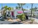Charming single-story home with a pink door, awnings, brick pathway and beautiful landscaping at 4851 W Gandy Blvd # B3L35, Tampa, FL 33611