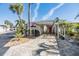 Inviting home with a covered carport and brick-paved driveway, enhanced by lush palm trees at 4851 W Gandy Blvd # B3L35, Tampa, FL 33611