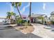 Cozy home with a covered carport, charming pink accents, and a well-maintained front yard at 4851 W Gandy Blvd # B3L35, Tampa, FL 33611