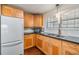 A modern kitchen with wood cabinets and a white refrigerator, toaster, and mixer at 4851 W Gandy Blvd # B3L35, Tampa, FL 33611