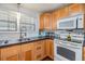 An organized kitchen with wood cabinets, lots of countertop space, and modern appliances at 4851 W Gandy Blvd # B3L35, Tampa, FL 33611