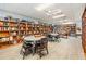 Community library with floor-to-ceiling bookshelves, laminate floors, tables and ceiling fans for comfortable reading at 4851 W Gandy Blvd # B3L35, Tampa, FL 33611