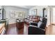 Inviting living room with wood floors, a leather sofa, and abundant natural light from the large window at 4851 W Gandy Blvd # B3L35, Tampa, FL 33611