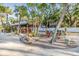 Outdoor pavilion with picnic tables and benches in a sandy area with mature trees and landscaping at 4851 W Gandy Blvd # B3L35, Tampa, FL 33611