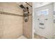 Updated shower features stylish tile, a rainfall showerhead, and modern fixtures at 4851 W Gandy Blvd # B3L35, Tampa, FL 33611