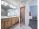 This bathroom boasts double sinks, light wood cabinetry, and tile flooring at 4910 Pond Ridge Dr, Riverview, FL 33578