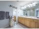 Bright bathroom with double sinks, large mirrors and a shower-tub combo at 4910 Pond Ridge Dr, Riverview, FL 33578