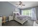 Comfortable bedroom with natural light, ceiling fan, and floral bedding at 4910 Pond Ridge Dr, Riverview, FL 33578
