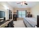 This comfortable bedroom offers plenty of natural light, a ceiling fan and desk area at 4910 Pond Ridge Dr, Riverview, FL 33578