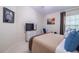 Cozy bedroom showcasing neutral paint, tv, and decor at 4910 Pond Ridge Dr, Riverview, FL 33578