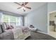 This spacious bedroom features a ceiling fan, large windows and wood-look floors at 4910 Pond Ridge Dr, Riverview, FL 33578