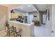 An open-concept kitchen featuring light wood cabinets and an adjacent dining area with tile floors at 4910 Pond Ridge Dr, Riverview, FL 33578