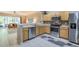 Modern kitchen with stainless steel appliances and an open view to the living room at 4910 Pond Ridge Dr, Riverview, FL 33578
