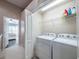 A conveniently located laundry room with white appliances and ample storage at 4910 Pond Ridge Dr, Riverview, FL 33578