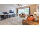 Cozy living room with tile floors, a ceiling fan, and sliding glass doors to the screened patio at 4910 Pond Ridge Dr, Riverview, FL 33578