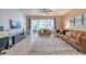 Spacious living room with comfortable seating, ceiling fan, and sliding doors leading to outdoor living space at 4910 Pond Ridge Dr, Riverview, FL 33578