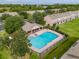 Aerial view of a community pool and lounge area surrounded by lush landscaping and townhomes at 4910 Pond Ridge Dr, Riverview, FL 33578