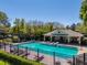 Resort-style community pool with surrounding brick and stylish clubhouse for residents' relaxation at 4910 Pond Ridge Dr, Riverview, FL 33578