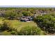 Aerial view of the home with a spacious yard and mature trees at 498 Lakewood Dr, Brandon, FL 33510