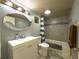 Bathroom with vanity and white cabinet, tiled shower and tub with updated fixtures at 498 Lakewood Dr, Brandon, FL 33510