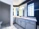 Stylish bathroom with marble floors, a large mirror, and modern lighting, offering a clean and sophisticated design at 498 Lakewood Dr, Brandon, FL 33510