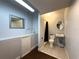 Simple bathroom with wood and tile floors, a sink, toilet, and shower providing functionality at 498 Lakewood Dr, Brandon, FL 33510