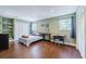 Cozy bedroom with hardwood floors, two windows with blue curtains, and closet for storage at 498 Lakewood Dr, Brandon, FL 33510